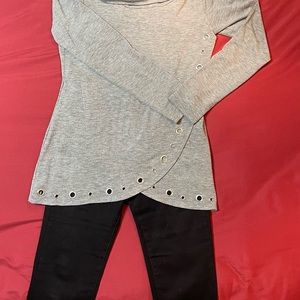 Gray tunic top with grommets accenting the cross over front.